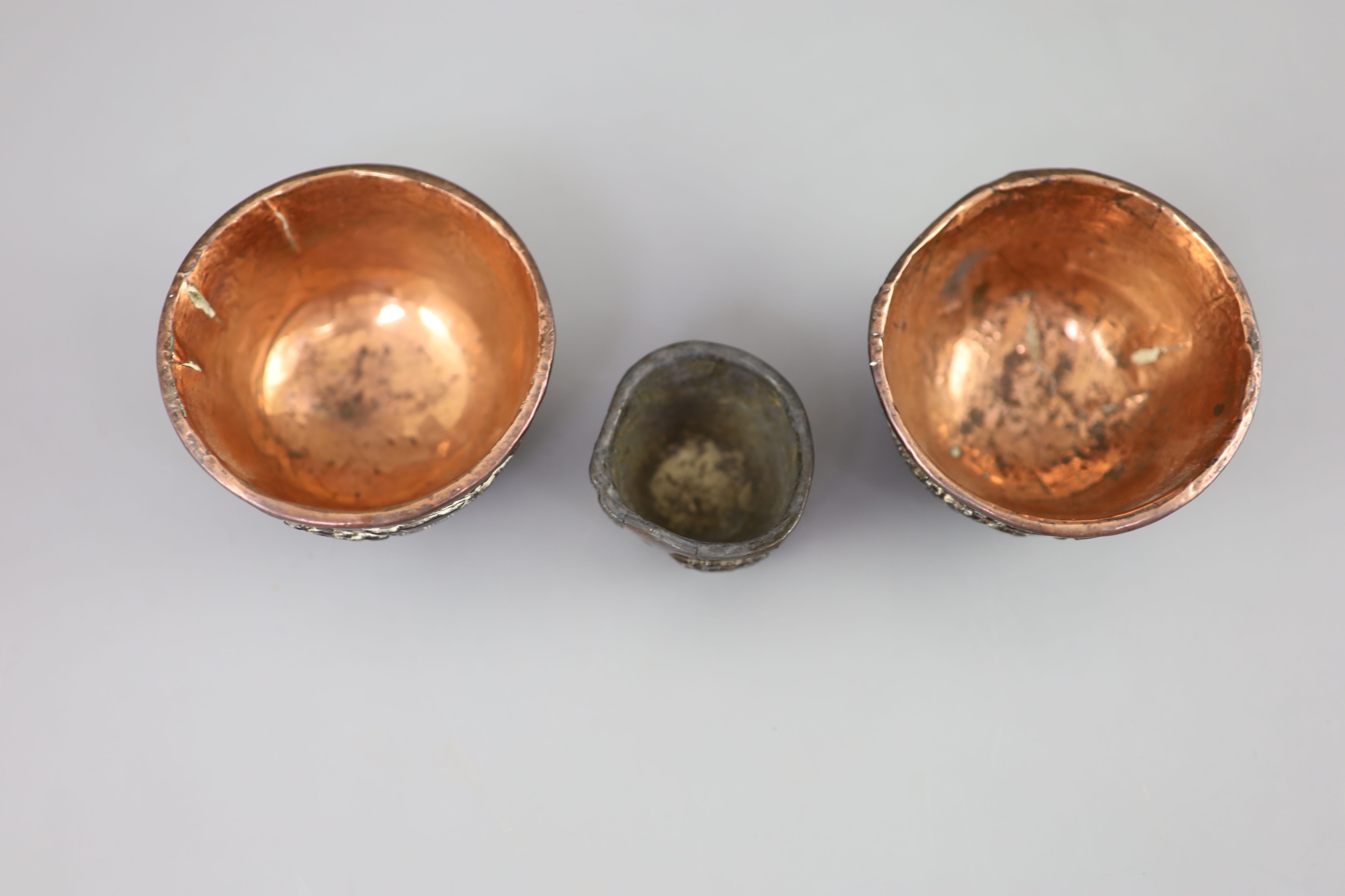 A pair of Chinese coconut landscape cups and a similar peach-shaped cup, 18th/19th century,